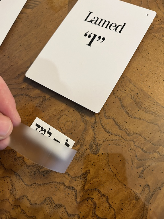 Lamed flashcard with its printed Hebrew name being positioned